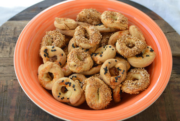 Traditional homemade Middle East salty sesame ring cookies with  cumin and black sesame in an orange bowl