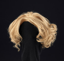 wavy blonde hair wig on black background