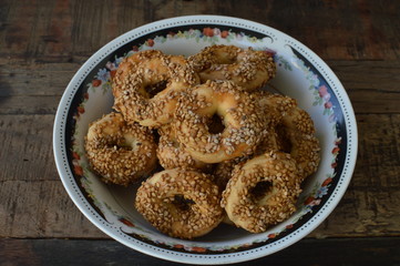 Traditional Turkish salty sesame pastry, tuzlu kurabiye, cachkitas in the ethno bowl on the rustic wooden table