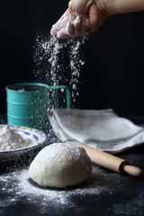 Dough ,making dough with flour on a black background, bread and pizza dough