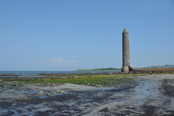 Fototapeta premium Old Lighthouse on the shore. The Chaine Memorial Tower in Larne, County Antrim, Northern Ireland.