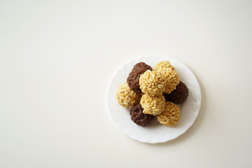  sweet dessert, cakes cake lie on a white plate on a white table stacked on top of each other round shape chocolate and yellow, located on the side, place for the inscription