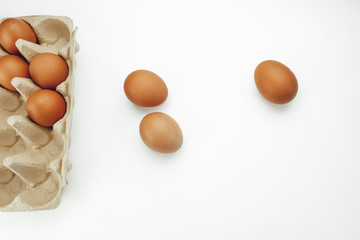 
three eggs and eggs in a box on a white background