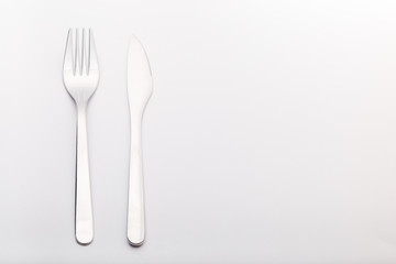 Silverware set knife and fork on a gray background, horizontal, copy space