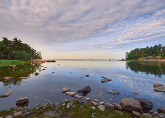 Summer walk along the Gulf of Finland on a wonderful calm morning in Lauttasaari next to the...