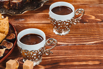 Two cups of coffee with traditional turkish desserts