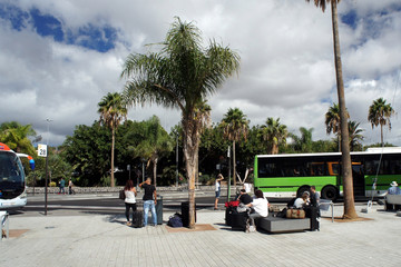 Tourists arriving in Tenerife waiting for a bus at the island's Southern Airport.