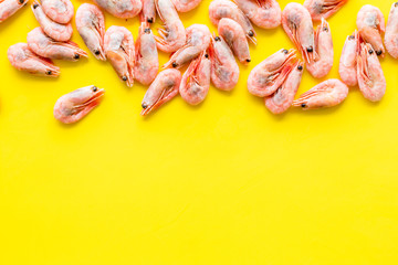 Shrimps background on yellow table top view frame copy space