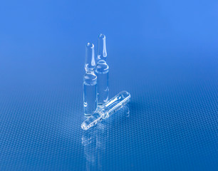 Three ampoules in the foreground.