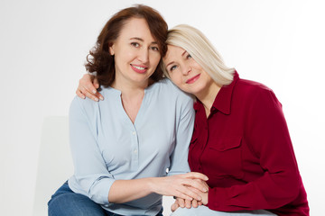 Happy menopause concept. Two healthy and beautiful middle aged women isolated on white background. Woman support woman. Closeup faces and skincare makeup.