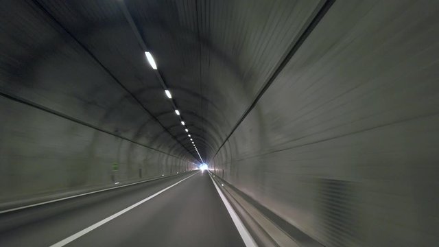 Spooky and empty underground tunnel road for cars. Logistics and transportations concept under water or mountains. Engineering solutions for long distance travel