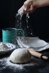 Dough ,making dough with flour on a black background, bread and pizza dough