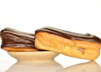 Sweet, mouth-watering chocolate eclairs, close-up, on a white background.