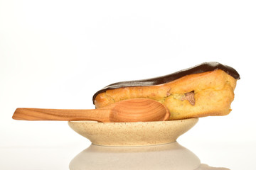 Sweet, mouth-watering chocolate eclairs, close-up, on a white background.