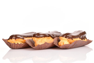 Sweet, mouth-watering chocolate eclairs, close-up, on a white background.