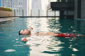 Carefree man relax in swimming pool