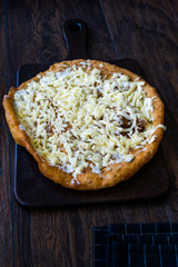 Traditional Langos / Langosh are originally Hungarian fried pancakes made from yeast dough, topped with Parmesan cheese and Mild Cream Cheese / Pisi.