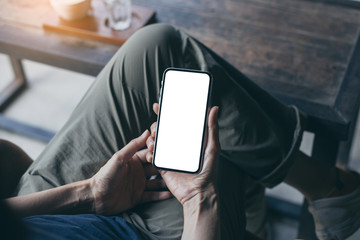 cell phone Mockup image blank white screen.woman hand holding texting using mobile on desk at coffee shop.background empty space for advertise.work people contact marketing business,technology