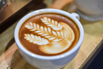 Shapes of art coffee on white cups.