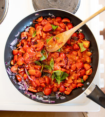 Delicious home made tomato and basil pasta sauce on the hob simmering and cooking