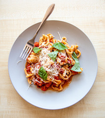 A fresh plate of delicious pasta with tomato and basil sauce made the traditional Italian way