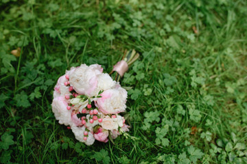 Bridal bouquet on the green grass.