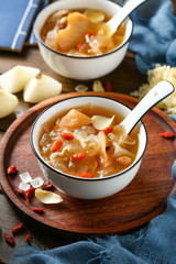 White fungus soup and pear in white bowl on wooden plate
