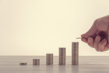 Money stack on wooden table. Concept for property ladder, mortgage and real estate investment. Investment and business growth concept.