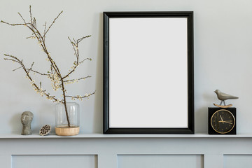 Minimalistic concept on the shelf with black mock up photo frame, dired flower in vase, black clock...
