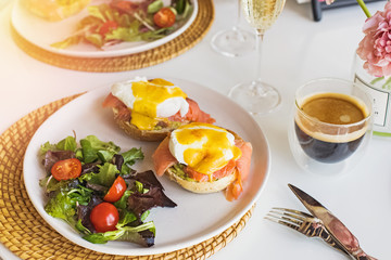 Sunday brunch with eggs benedict, salad and coffee