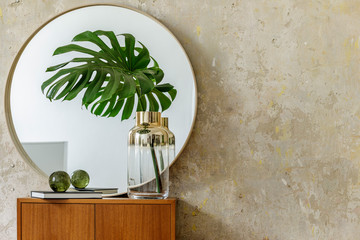 Minimalistic composition at modern retro interior with design commode, tropical leaves in vase,...