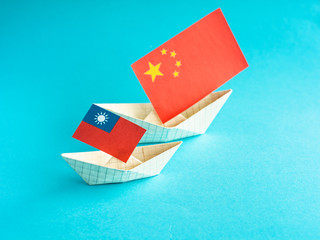 paper ship with national flag of china and Taiwan, concept of conflict, shipment or free trade...