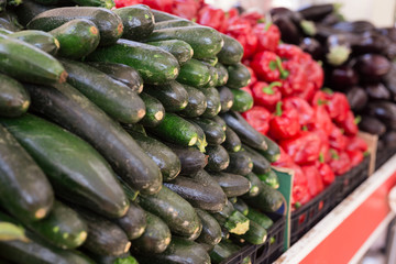 fresh mature zucchini on the market counter
