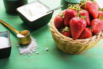 Strawberries in the basket on the wooden table
