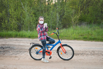 girl in a mask on a Bicycle