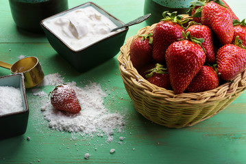 Strawberries in the basket on the wooden table