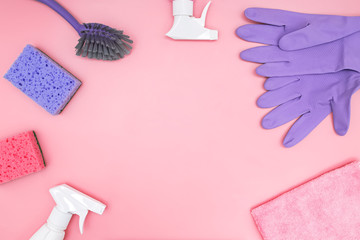 Cleaning tools and supplies on pink background