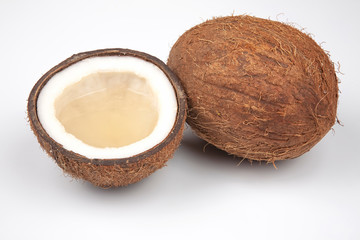 cut fresh coconut with real coconut milk on a white background. vitamin fruits. healthy food