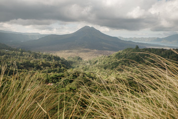 View of volcano Batur (Gunung Batur) and Lake Batur (Danau Batur). Kintamani, Bangli, Bali, Indonesia.  A panoramic view of Mount Batur and Lake Batur