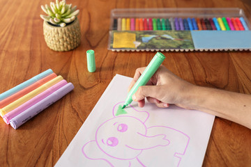 woman drawing with colored markers