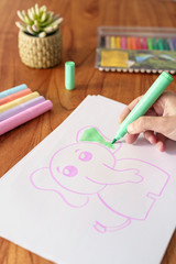 woman drawing with colored markers
