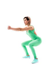 Obraz premium Studio shot of an athletic woman doing squats isolated over white background.