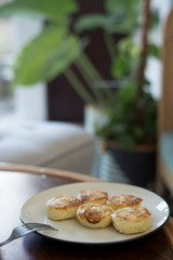 cottage cheese pancakes on a white plate on a wooden table