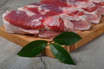raw pork belly slice on a wooden board. Sliced pork on a cutting board