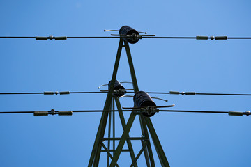electricity pylon against blue sky