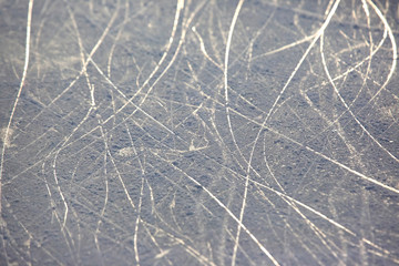 bright traces of ice skating on an ice rink. background and texture