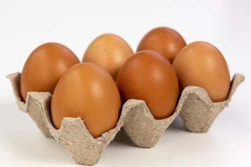 Raw Chicken eggs in cardboard egg box. Eggs in the package.