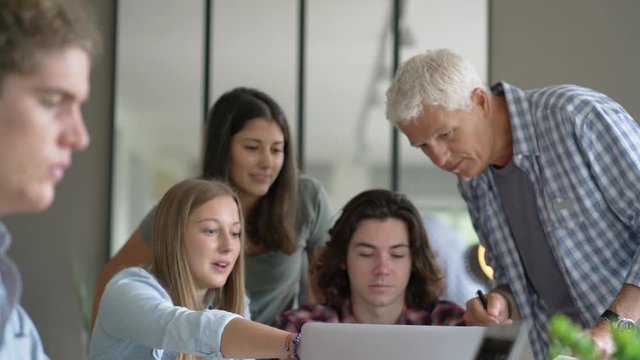 group of students working with a teacher