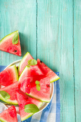 Watermelon slices on light blue wooden background