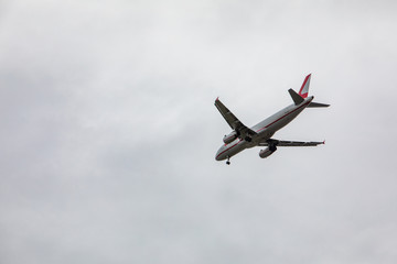 plane in sky landing overcast weather